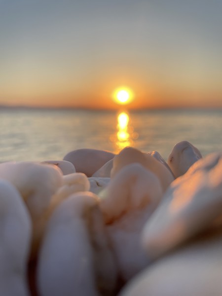 Beach, Flare, Light, Nature, Outdoors, Person, Sea, Sky, Stones, Sun, Sunlight, Sunrise, Sunset