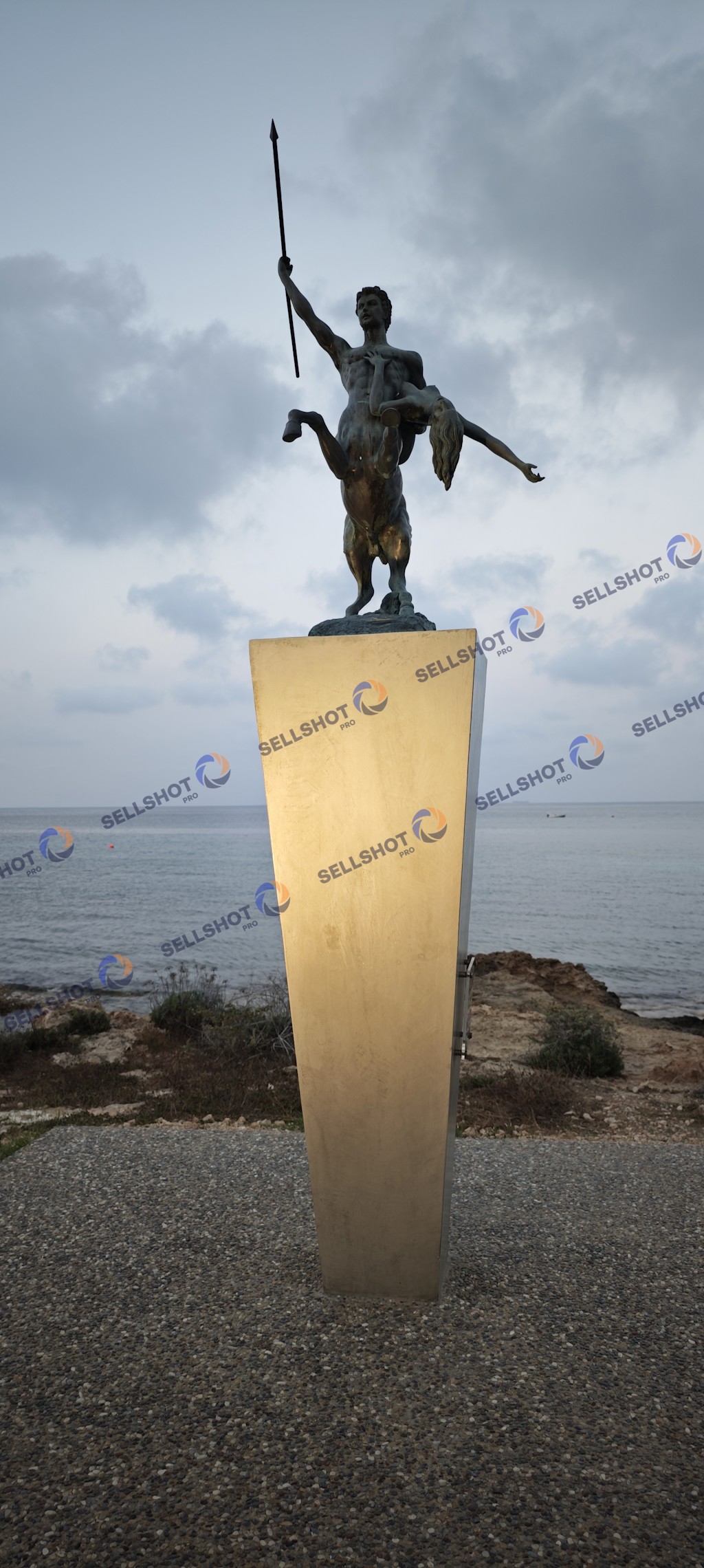 A collection of high-quality photographs featuring a dramatic centaur sculpture carrying a female figure, captured during sunset on the Cyprus coastline. Ideal for travel, mythology, culture, public art, editorial and commercial use.