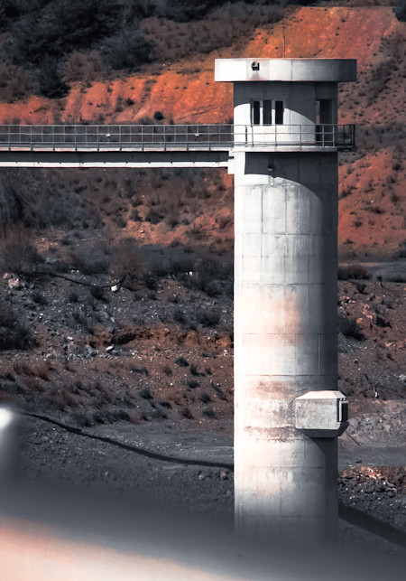 Industrial Tower Against Rocky Landscape