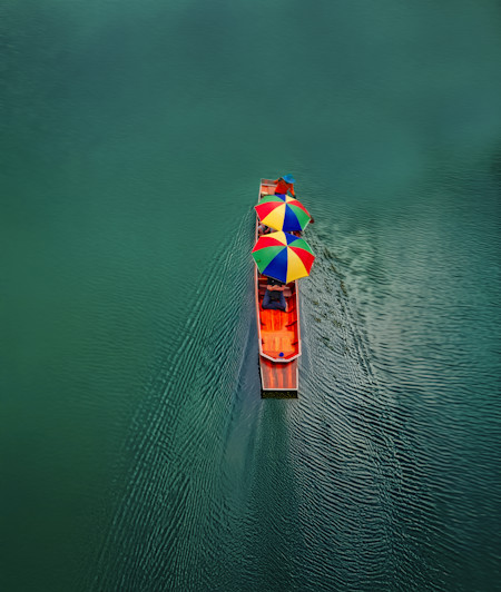 boat carrying tourists down a river